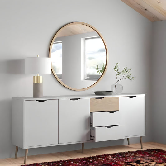 Modern sideboard with round mirror and decorative items in a room.