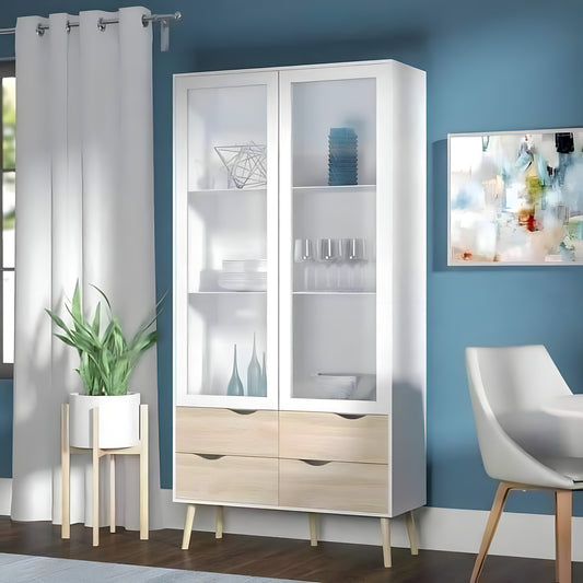 White display cabinet with glass doors and wooden drawers in a room with blue walls, a plant, and a chair.