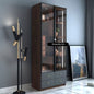 Modern interior design with a tall wooden cabinet, floor lamp, and framed picture.