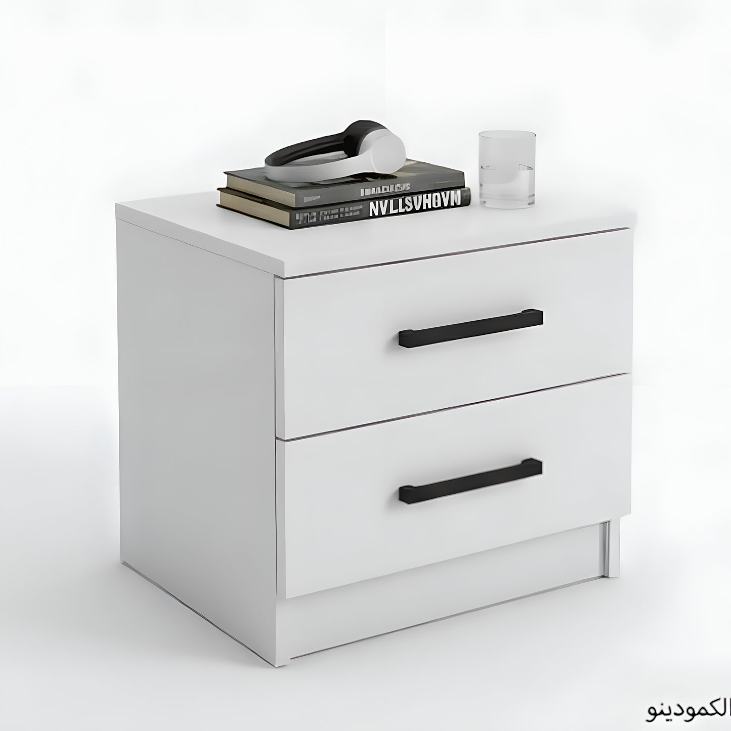 White nightstand with black handles on a white background