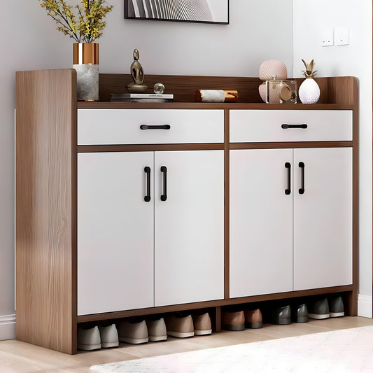 Wooden shoe cabinet with white doors and drawers, displaying shoes on a light wooden floor.