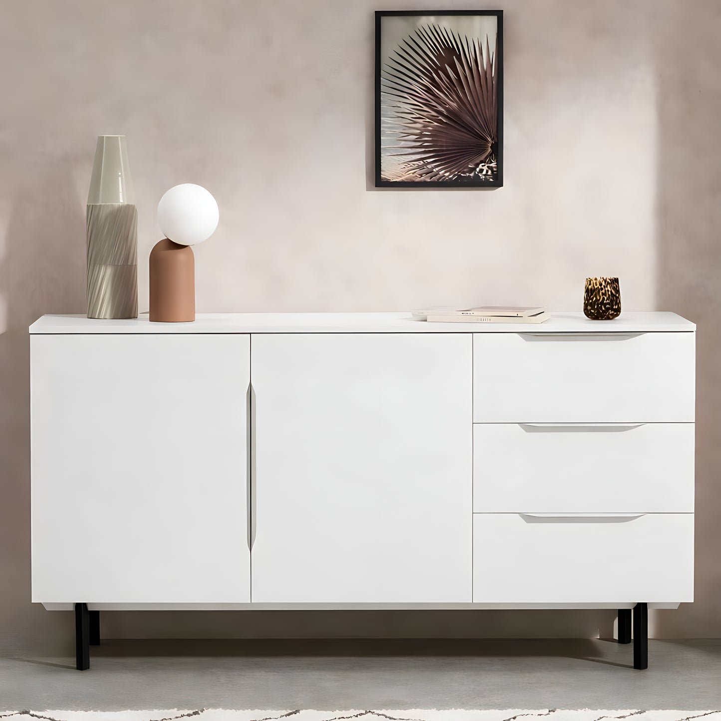 White sideboard with decorative items against a neutral wall.