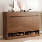 Wooden shoe cabinet with shoes inside, placed against a wall with decorative elements.