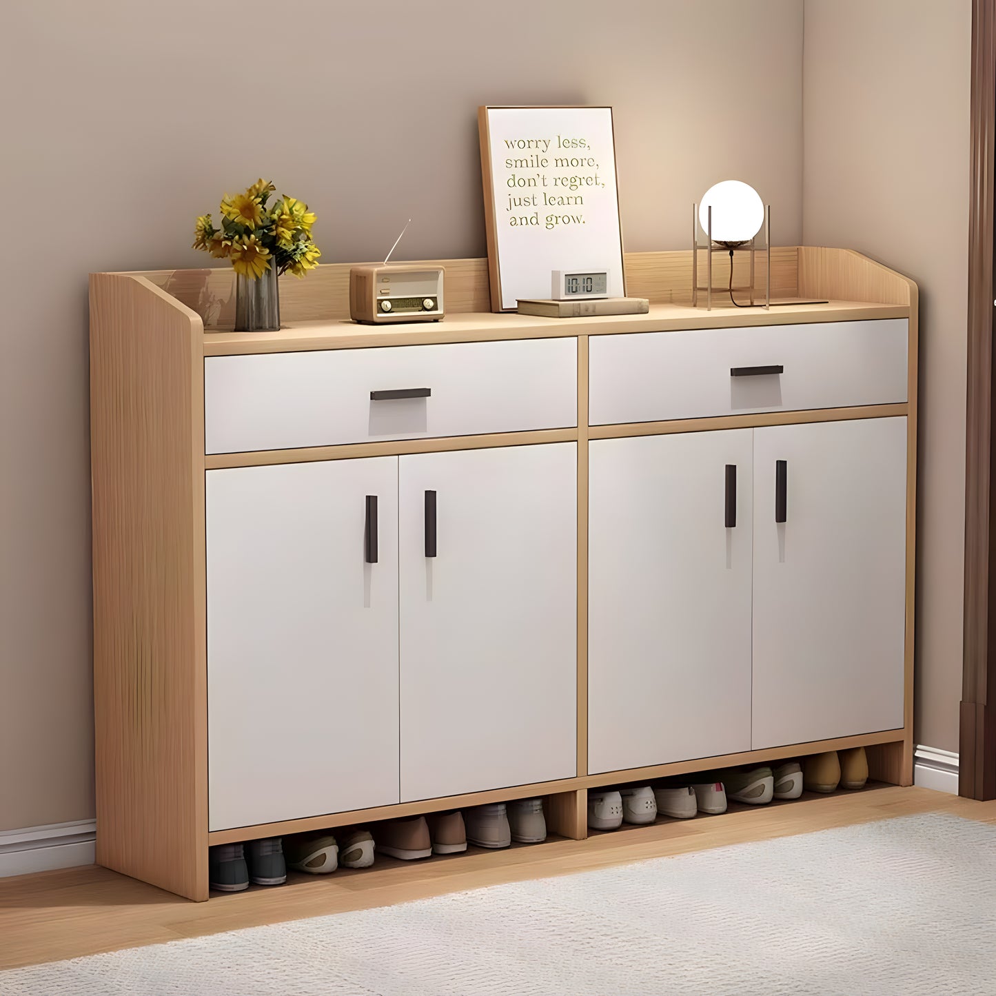 Wooden shoe cabinet with white doors and shoe storage space, placed against a beige wall.