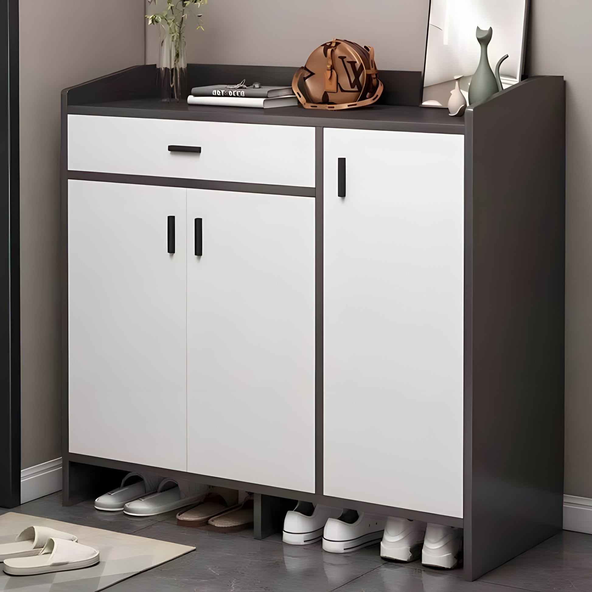 White shoe cabinet with black top and sides, shoes underneath, on a gray floor.
