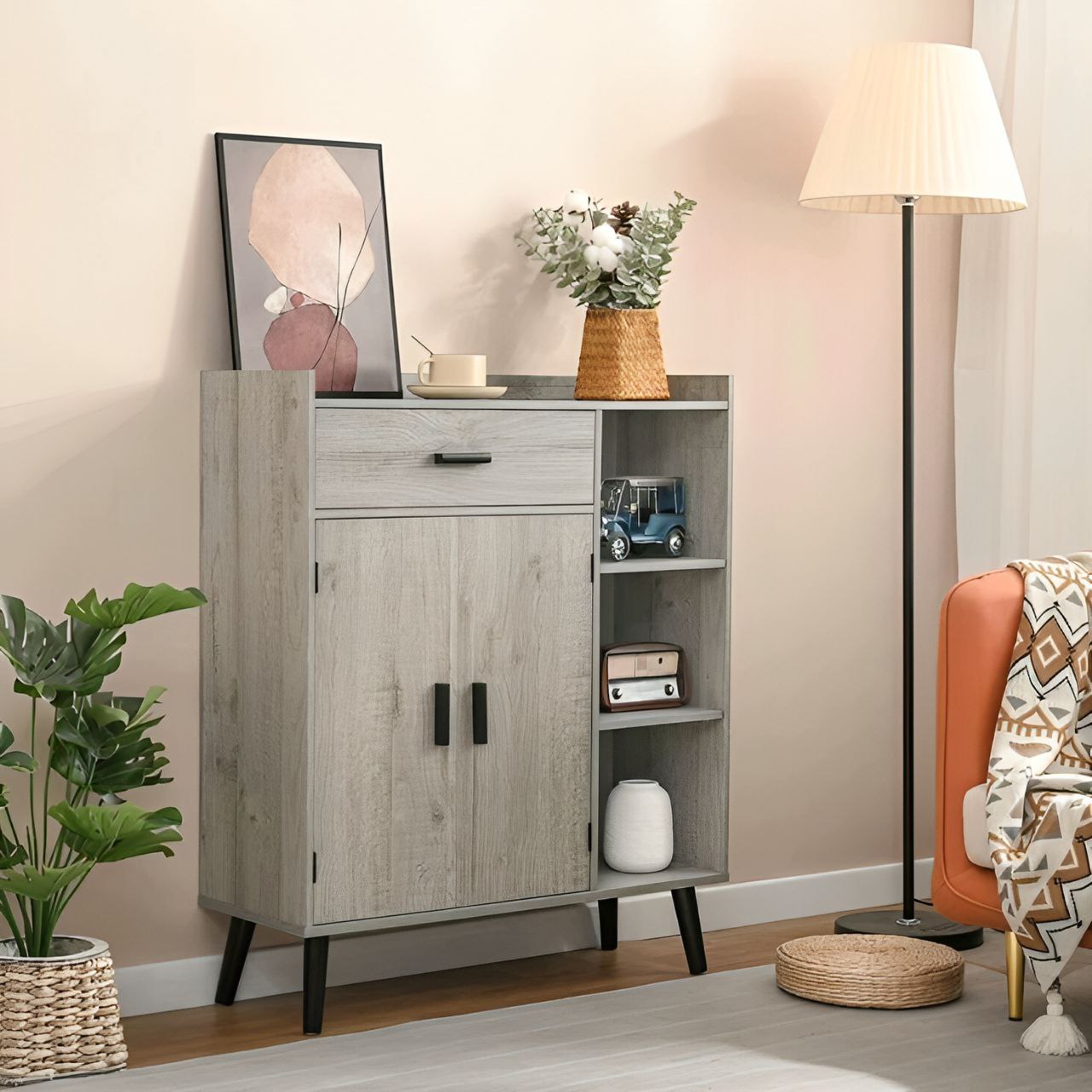 Wooden cabinet in a living room with decor items and a lamp.