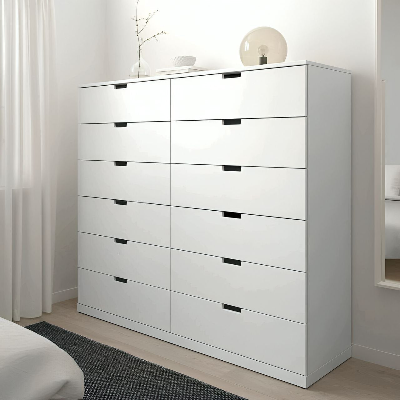 White dresser with multiple drawers in a bedroom setting