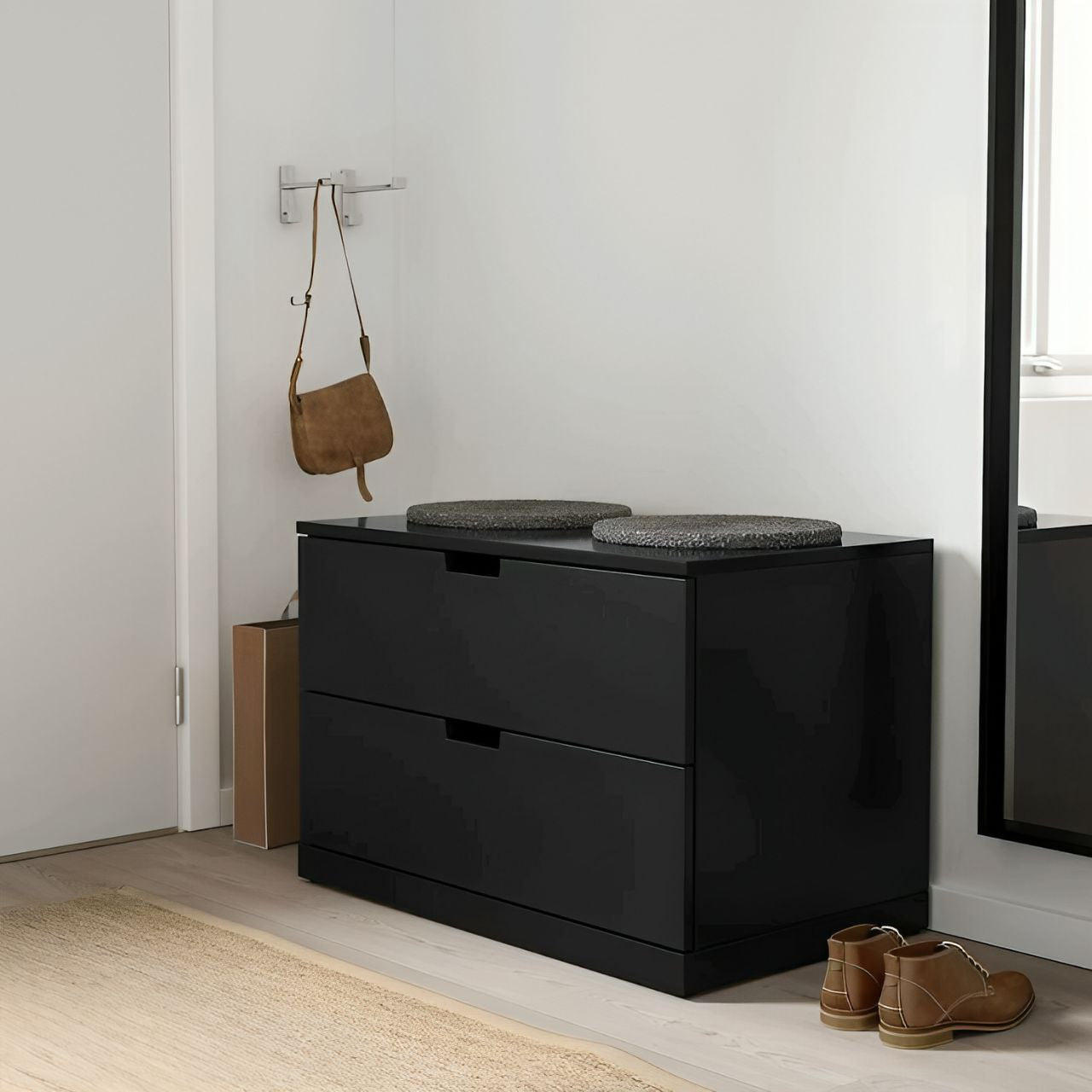 Black dresser with two drawers in a room setting with a handbag and shoes.