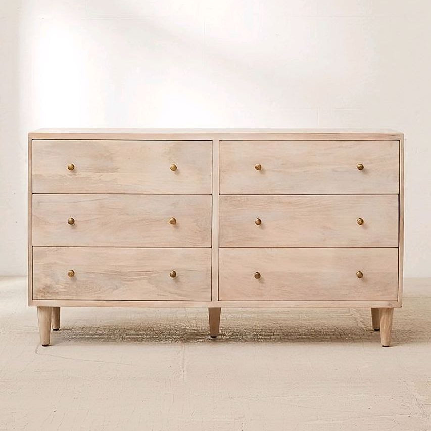 Light wooden dresser with six drawers on a plain background