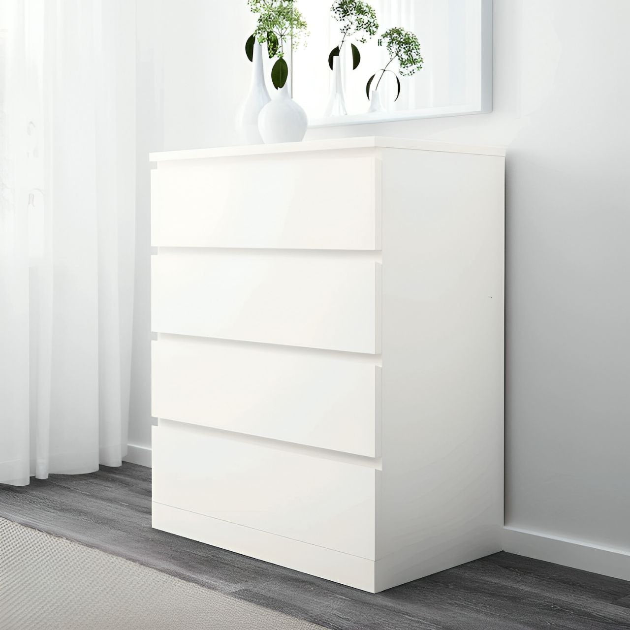 White dresser with decorative items in a minimalistic room