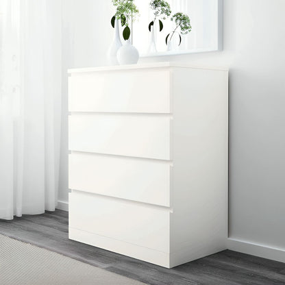 White dresser with decorative items in a minimalistic room