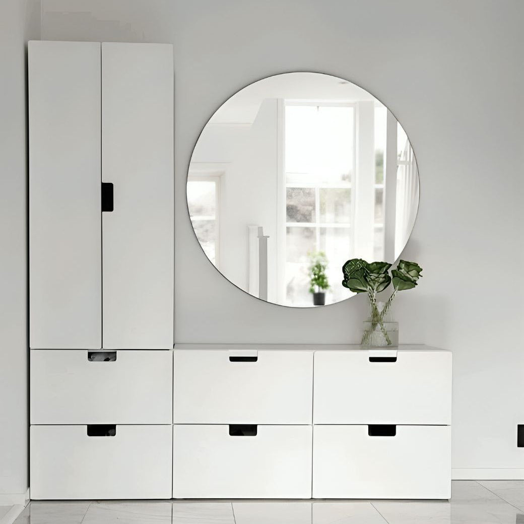 White dresser with round mirror in a minimalistic room