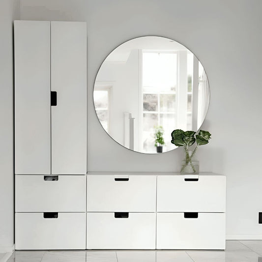 White dresser with round mirror in a minimalistic room