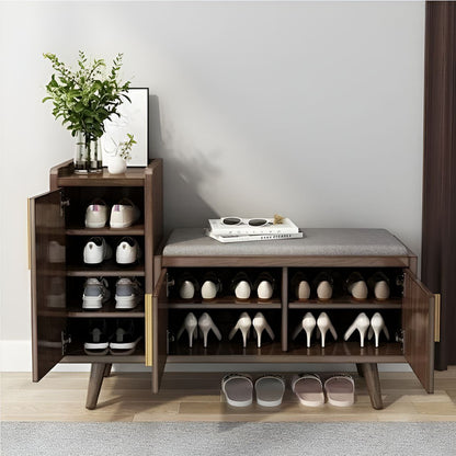 Wooden shoe cabinet with open doors displaying shoes, a plant, and books on a gray wall background.