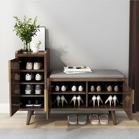 Wooden shoe cabinet with open doors displaying shoes, a plant, and books on a gray wall background.
