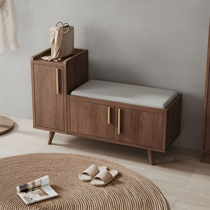 Wooden cabinet with a cushioned bench in a minimalistic room.