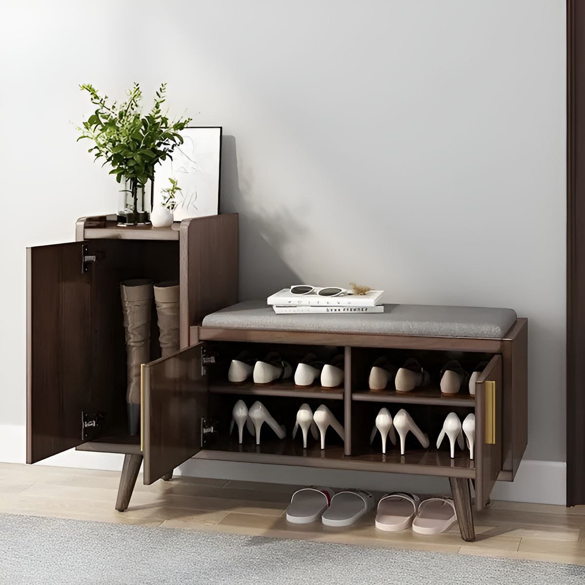 Wooden shoe cabinet with open doors displaying shoes, a cushioned bench, and a plant on a white wall.
