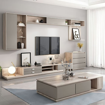 Modern living room with gray wall unit, TV, and coffee table.