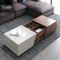 Modern living room with a white coffee table and wooden storage unit.
