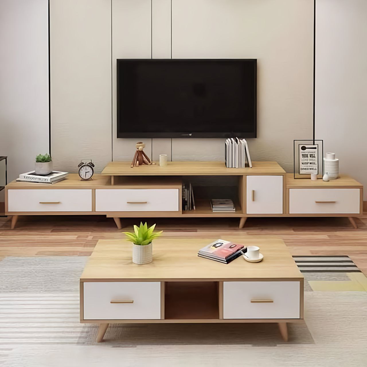 Modern living room with wooden TV stand and coffee table, featuring a television and decorative items.