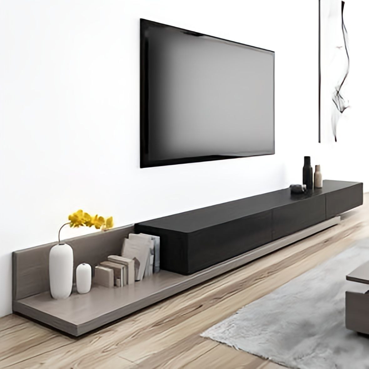 Modern living room with a long black TV stand and a mounted television.