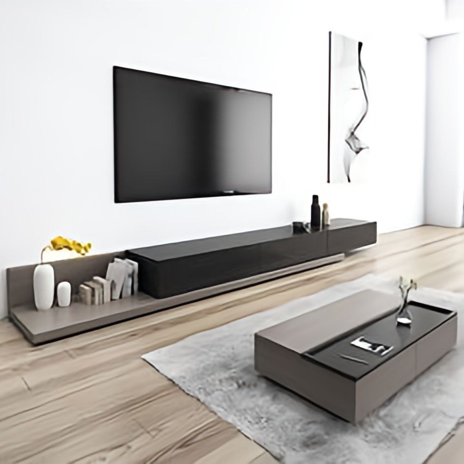 Modern living room with a television and decorative items on a wooden floor.
