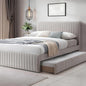 Gray upholstered bed with pull-out trundle in a modern bedroom setting.