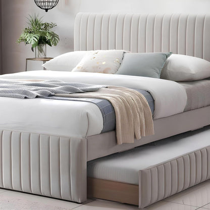 Beige upholstered bed with pull-out trundle in a bedroom setting.