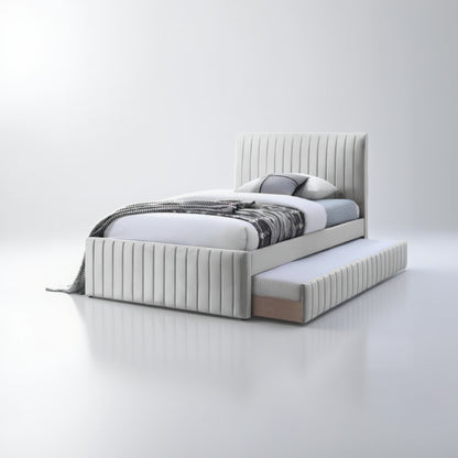 White upholstered bed with striped bedding and a trundle on a white background