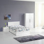 Modern bedroom with white bed, nightstand, and wardrobe against a gray wall.